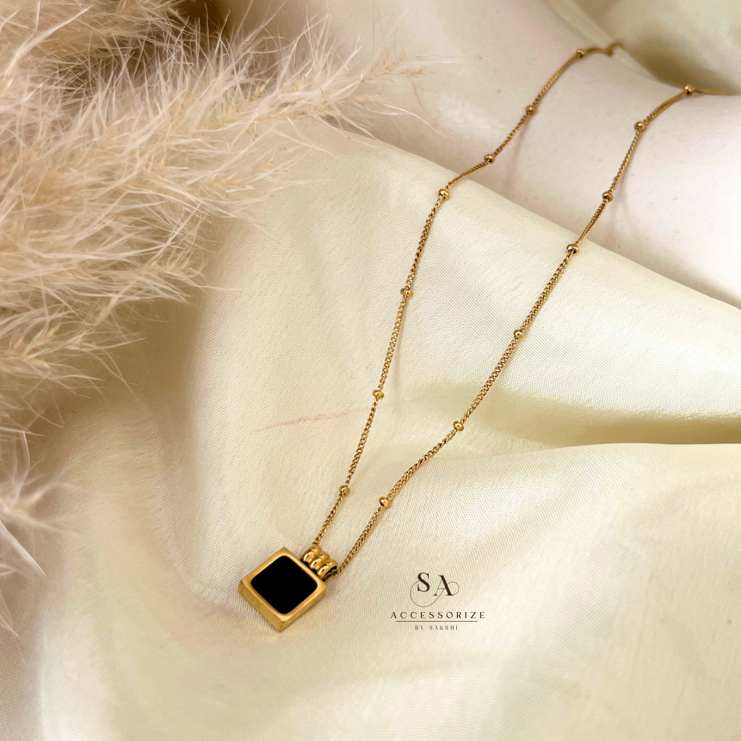 Knotted chain with black pendant